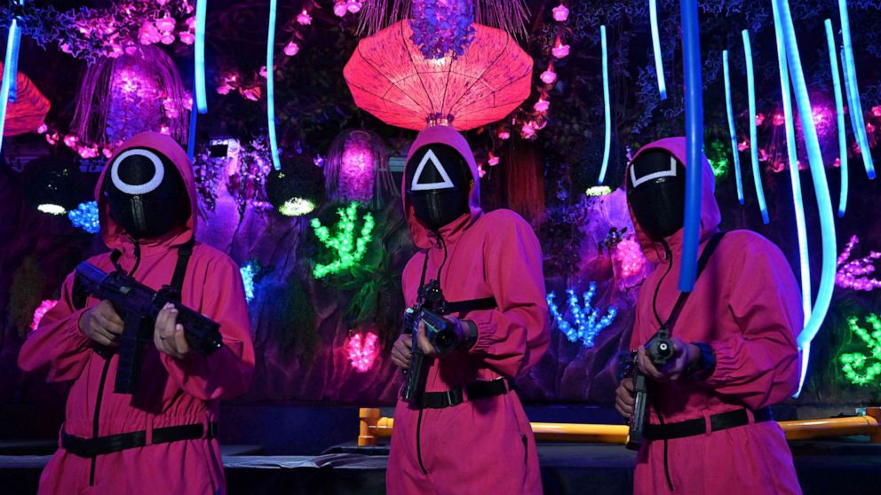 PHOTO: Waiters dressed in outfits from the Netflix series "Squid Game" pose while playing a game to attract customers at a cafe in Jakarta, Indonesia on Oct. 19, 2021.