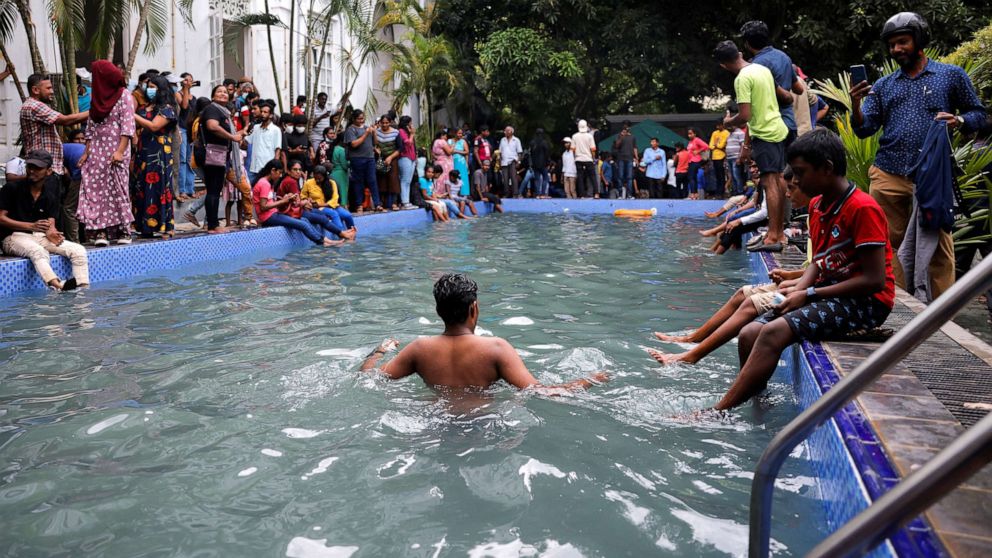 PHOTO: A man stands in the swimming pool as people visit the President's house on the day after demonstrators entered the building, after President Gotabaya Rajapaksa fled, amid the country's economic crisis, in Colombo, Sri Lanka, July 10, 2022.