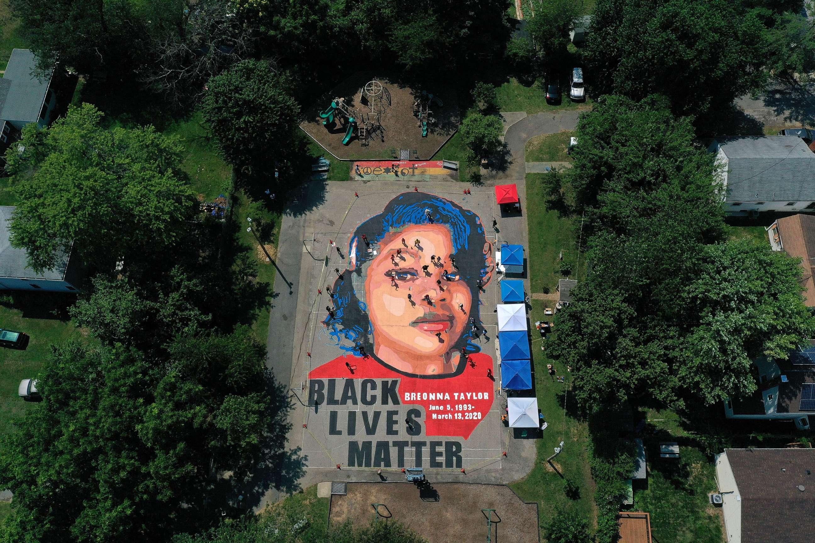 PHOTO: In an aerial view from a drone, a large-scale ground mural depicting Breonna Taylor with the text 'Black Lives Matter' is seen being painted at Chambers Park on July 5, 2020, in Annapolis, Md.
