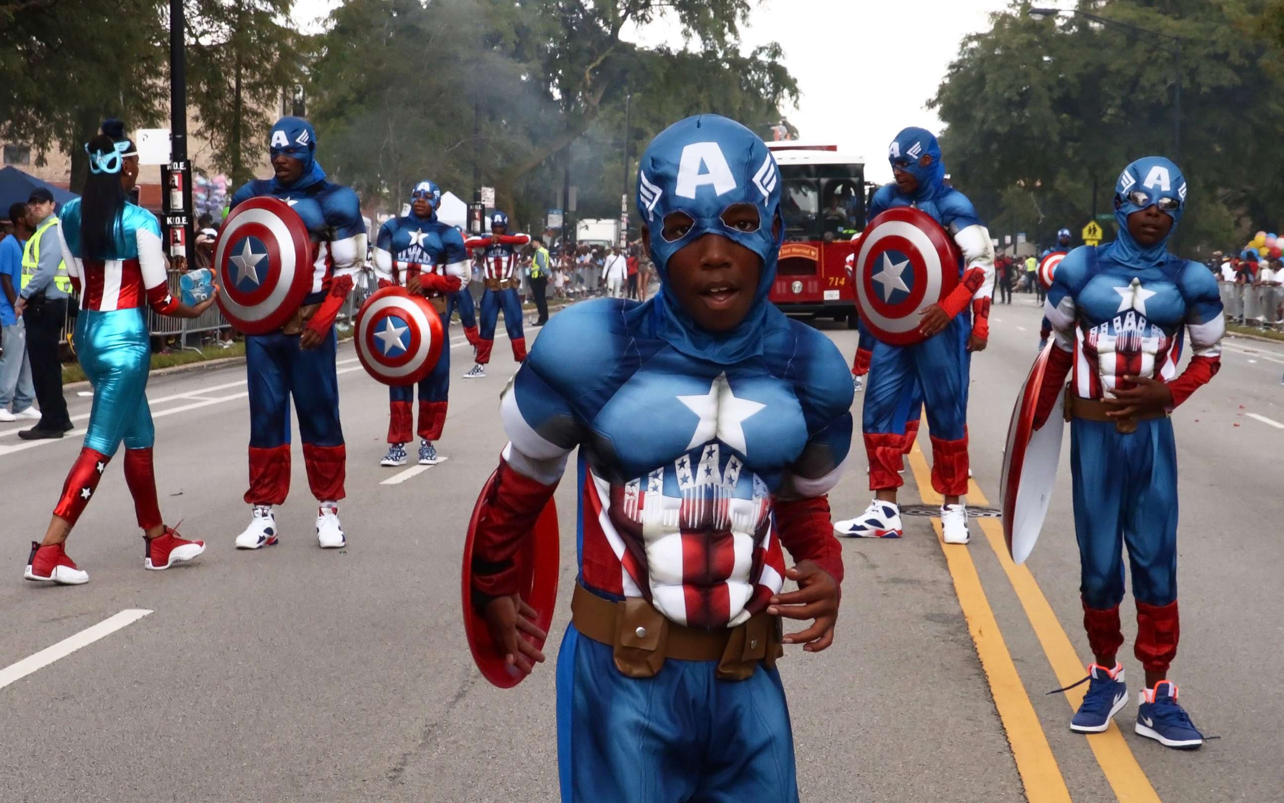 PHOTO: People dressed as Captain America march during the 87th "Bud Billiken Parade" on Martin Luther King Drive in Chicago, on Aug. 13, 2016.