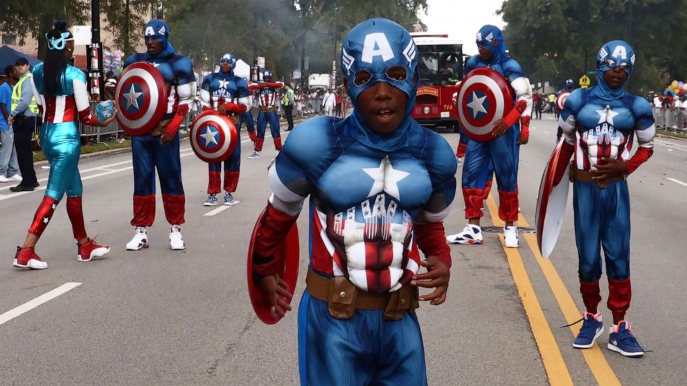 PHOTO: People dressed as Captain America march during the 87th "Bud Billiken Parade" on Martin Luther King Drive in Chicago, on Aug. 13, 2016.