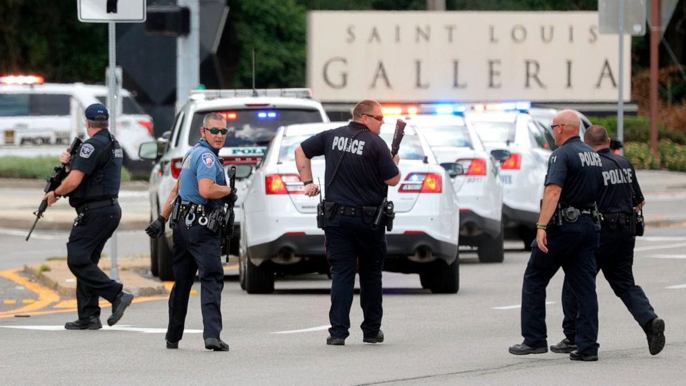 PHOTO: Police with their guns drawn search along Brentwood Boulevard near the St. Louis Galleria looking for a suspect in the reported shooting at the mall in the town of Richmond Heights near St. Louis, July 22, 2020.