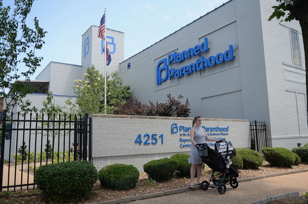 PHOTO: A women stands with her child in a stroller during a pro-life rally outside the Planned Parenthood Reproductive Health Center, June 4, 2019, in St Louis.