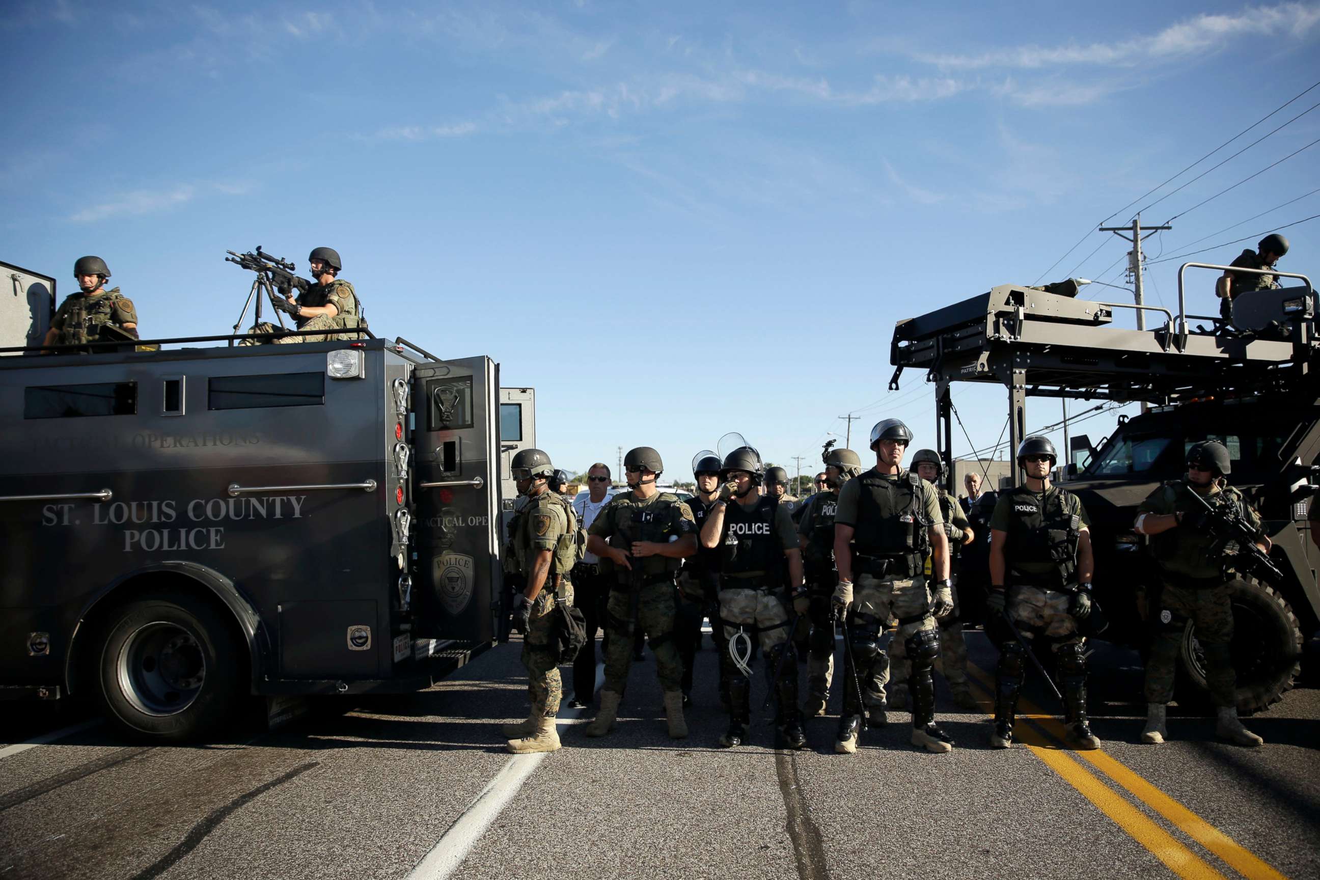 PHOTO: In this Aug. 13, 2014, file photo, police in riot gear watch protesters in Ferguson, Mo., during protests after the shooting of Michael Brown.