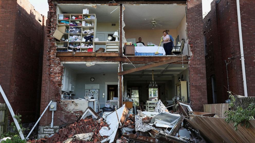 PHOTO: Residents inspect their home after a tornado completely tore off the back wall of a two-story house in St. Louis, Missouri, May 16, 2025. 