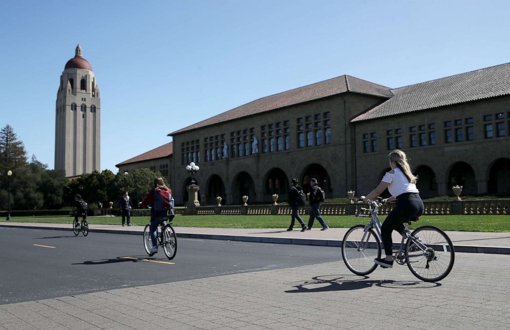 PHOTO: Cyclists ride by Hoover Tower on the Stanford University campus, March 12, 2019, in Stanford, Calif.