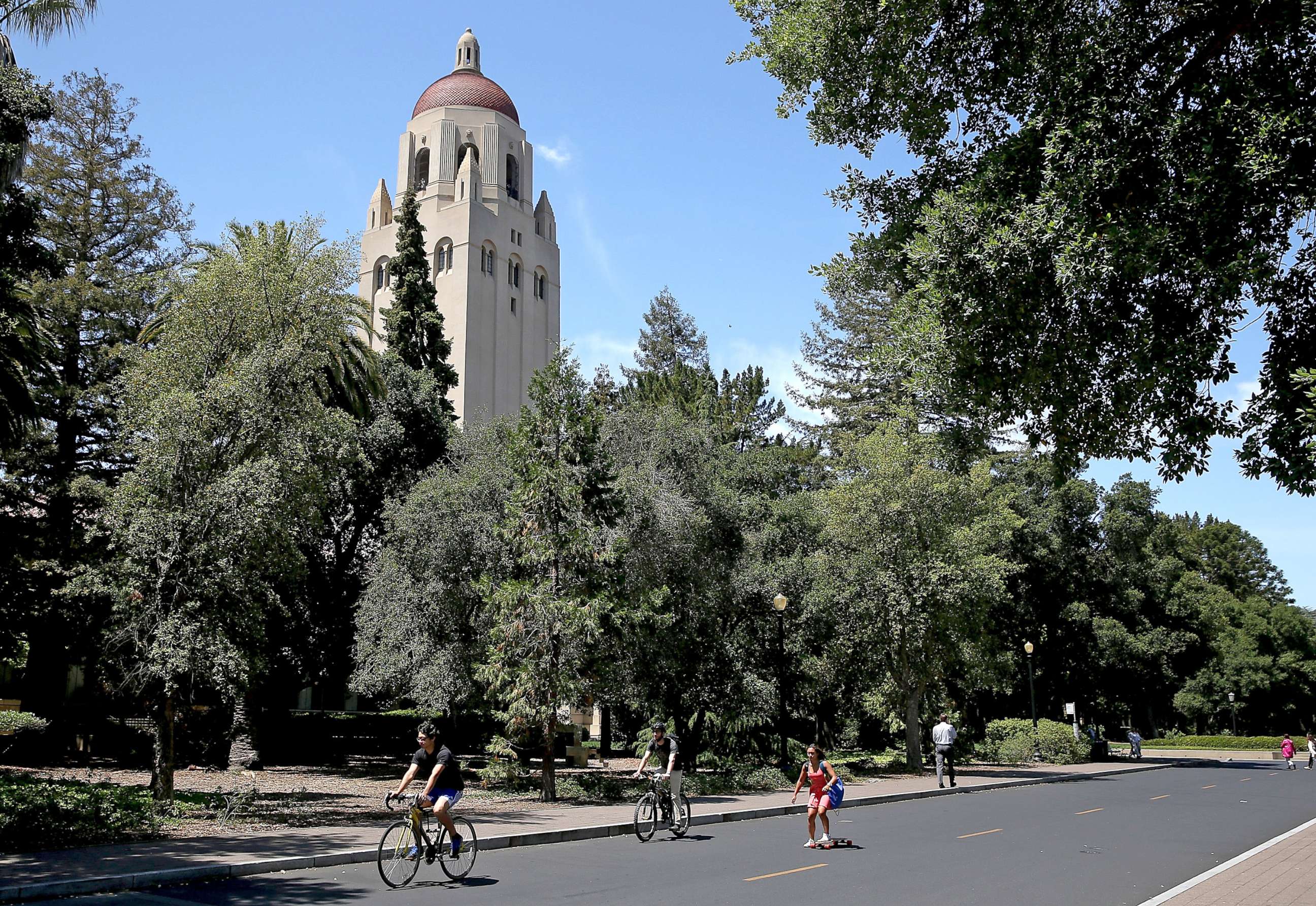 PHOTO: People ride bikes past Hoover Tower on the Stanford University campus on May 22, 2014 in Stanford, Calif.