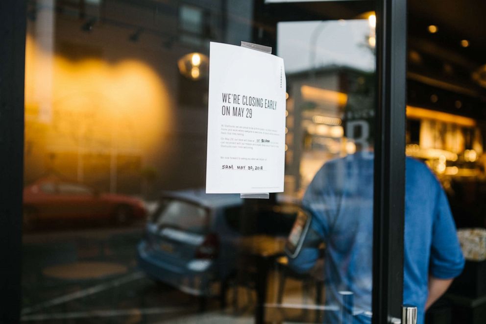 PHOTO: A sign displays early closing hours for racial bias training at a Starbucks coffee shop in Philadelphia, May 29, 2018.