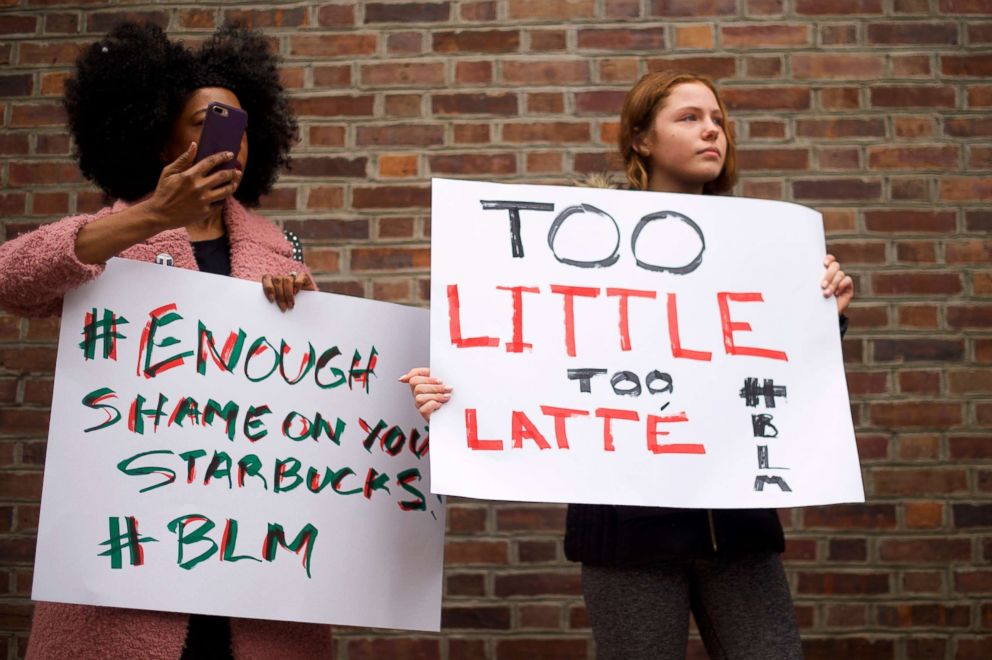 PHOTO: Pictured (L-R), mother and step-daughter, Donn T and Soren Mcclay demonstrate outside a Center City Starbucks, April 15, 2018 in Philadelphia.