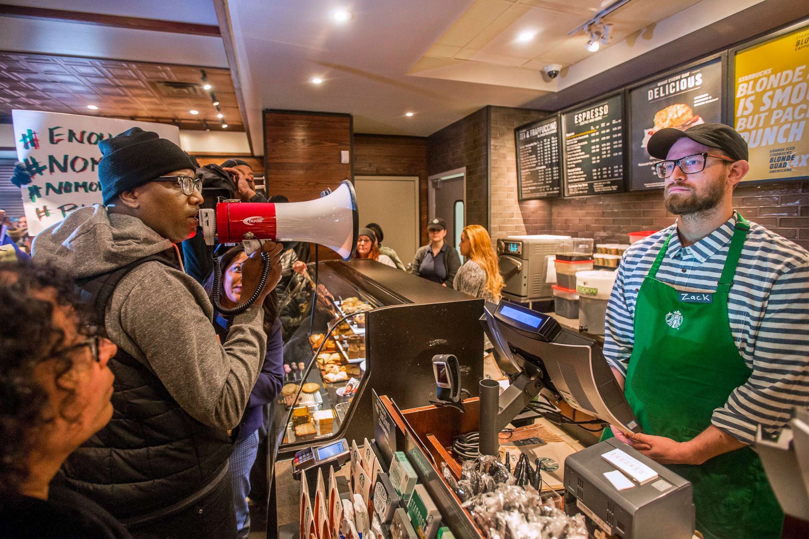 PHOTO: Asa Khalif, left, a Black Lives Matter activist from Philadelphia, demands the firing of a Starbucks cafe manager who called police, resulting in the arrest of two black men on April 12, 2018, at the Starbucks cafe in Philadelphia.