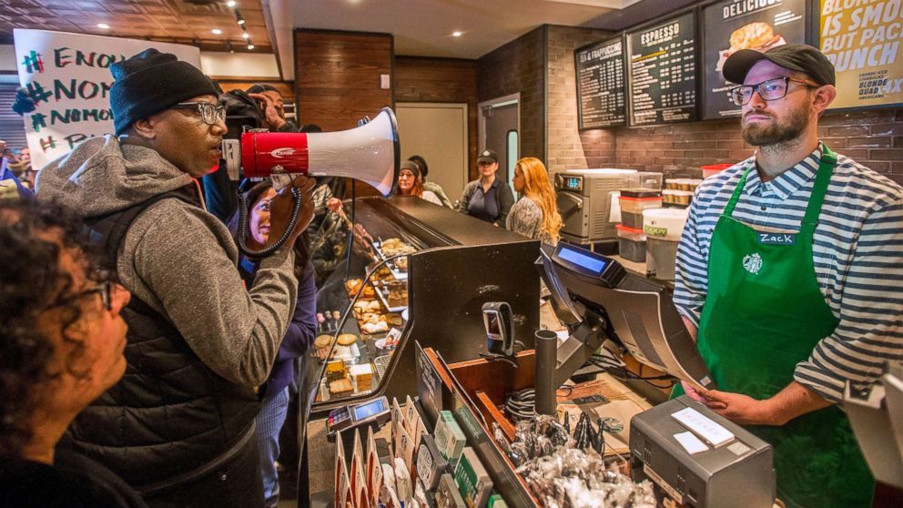 PHOTO: Asa Khalif, left, a Black Lives Matter activist from Philadelphia, demands the firing of a Starbucks cafe manager who called police, resulting in the arrest of two black men on April 12, 2018, at the Starbucks cafe in Philadelphia.