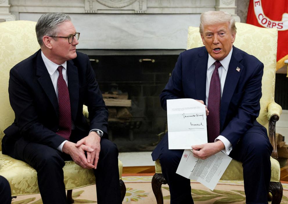 PHOTO: President Donald Trump holds a letter from Britain's King Charles as he meets with British Prime Minister Keir Starmer in the Oval Office at the White House in Washington, D.C., February 27, 2025.