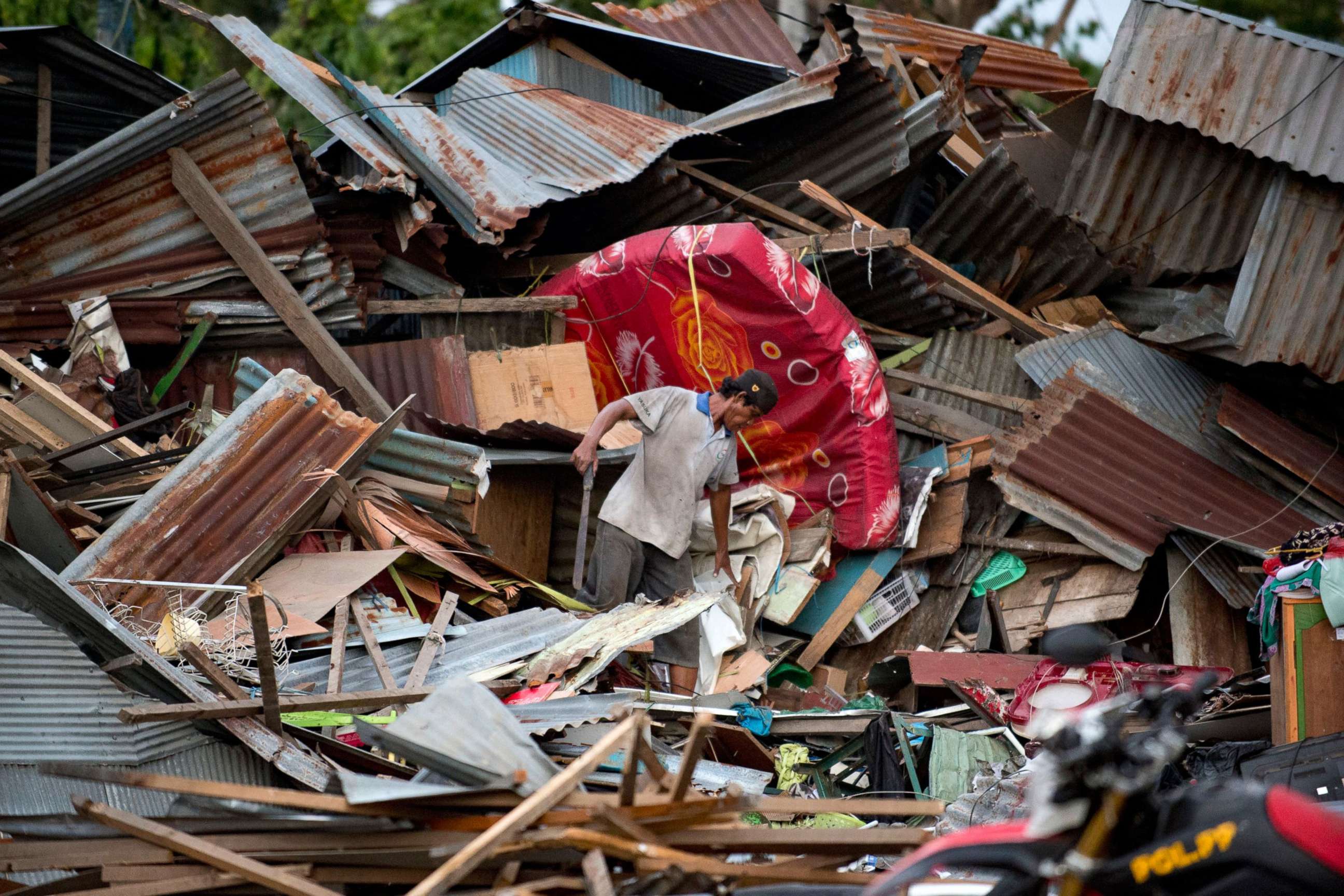 PHOTO: A man looks for his belongings amid the debris of his destroyed house in Palu in Central Sulawesi on Sept. 29, 2018, after a strong earthquake and tsunami struck the area.