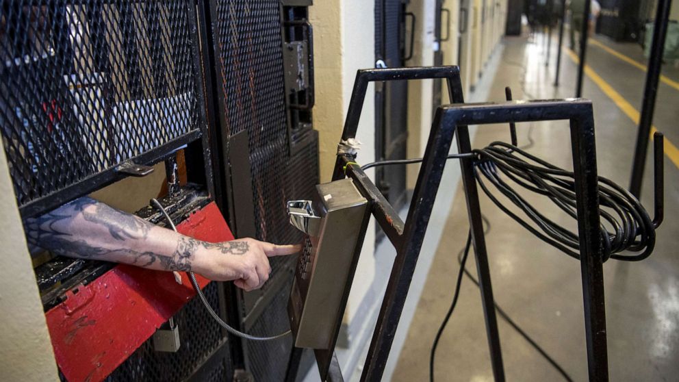 FILE PHOTO: An inmate uses a phone from a cell at San Quentin State Prison in San Quentin, Calif. August 28, 2019. 16, 2016.