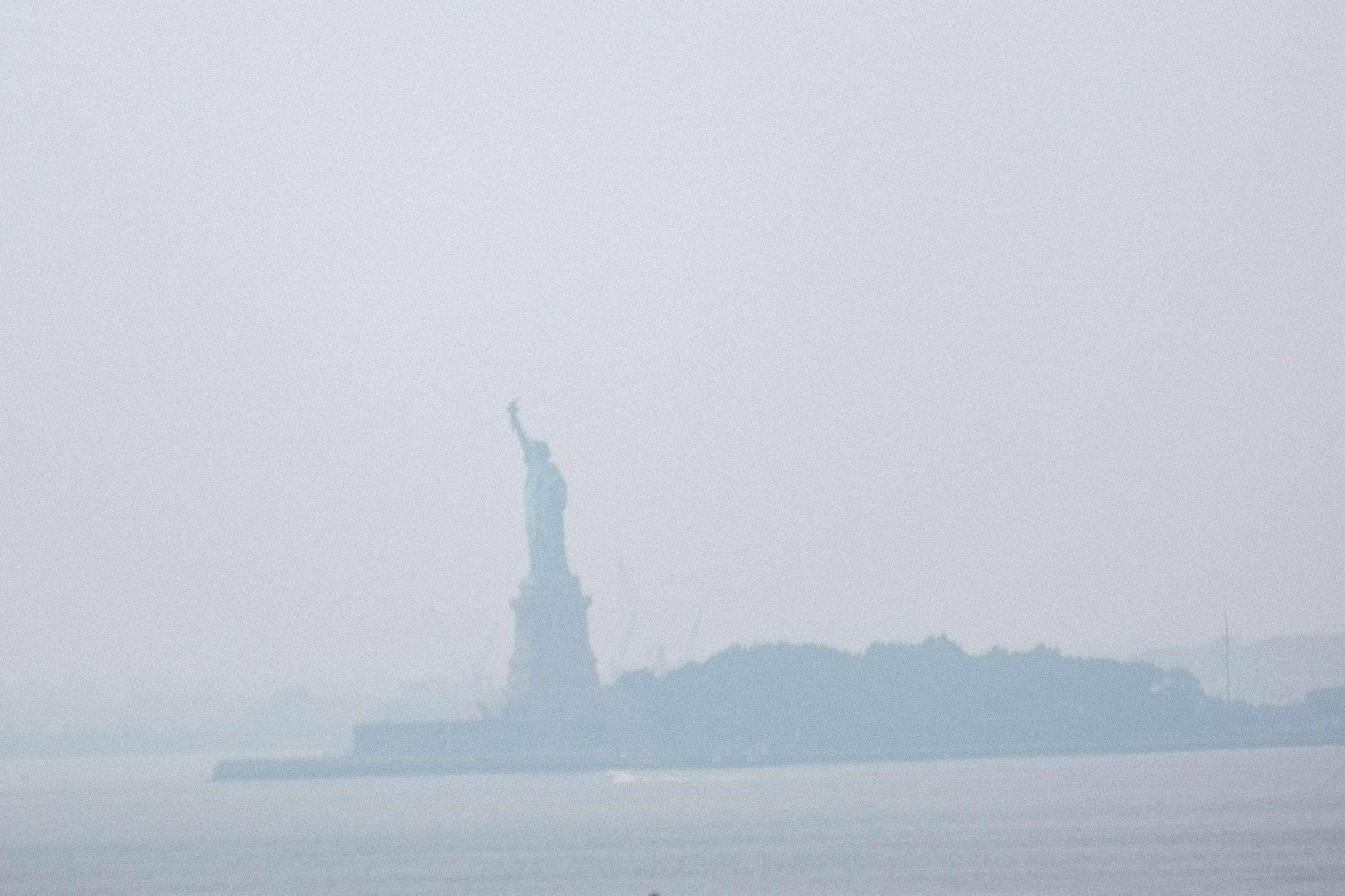 PHOTO: The Statue of Liberty sits behind a cloud of haze on July 20, 2021 in New York City.