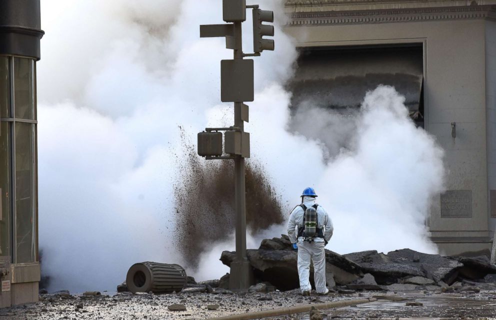 PHOTO: A worker looks at steam coming from 5th Avenue after a steam explosion tore apart the street in the Flatiron District of New York, July 19, 2018.