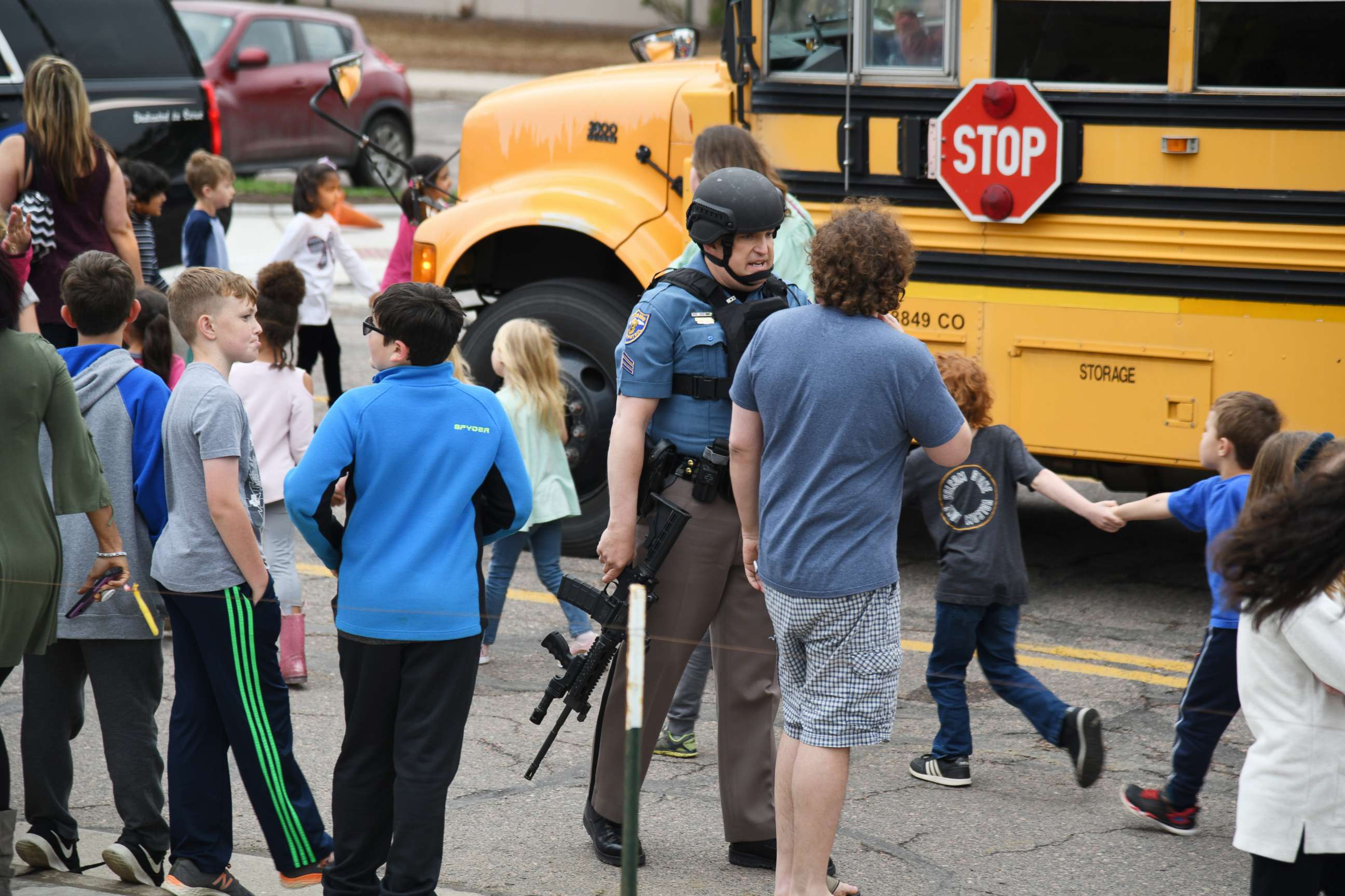 PHOTO: Students are escorted to a school bus in front of STEM School Highlands Ranch after a shooting, May 7, 2019, in  Highlands Ranch, Colo. 