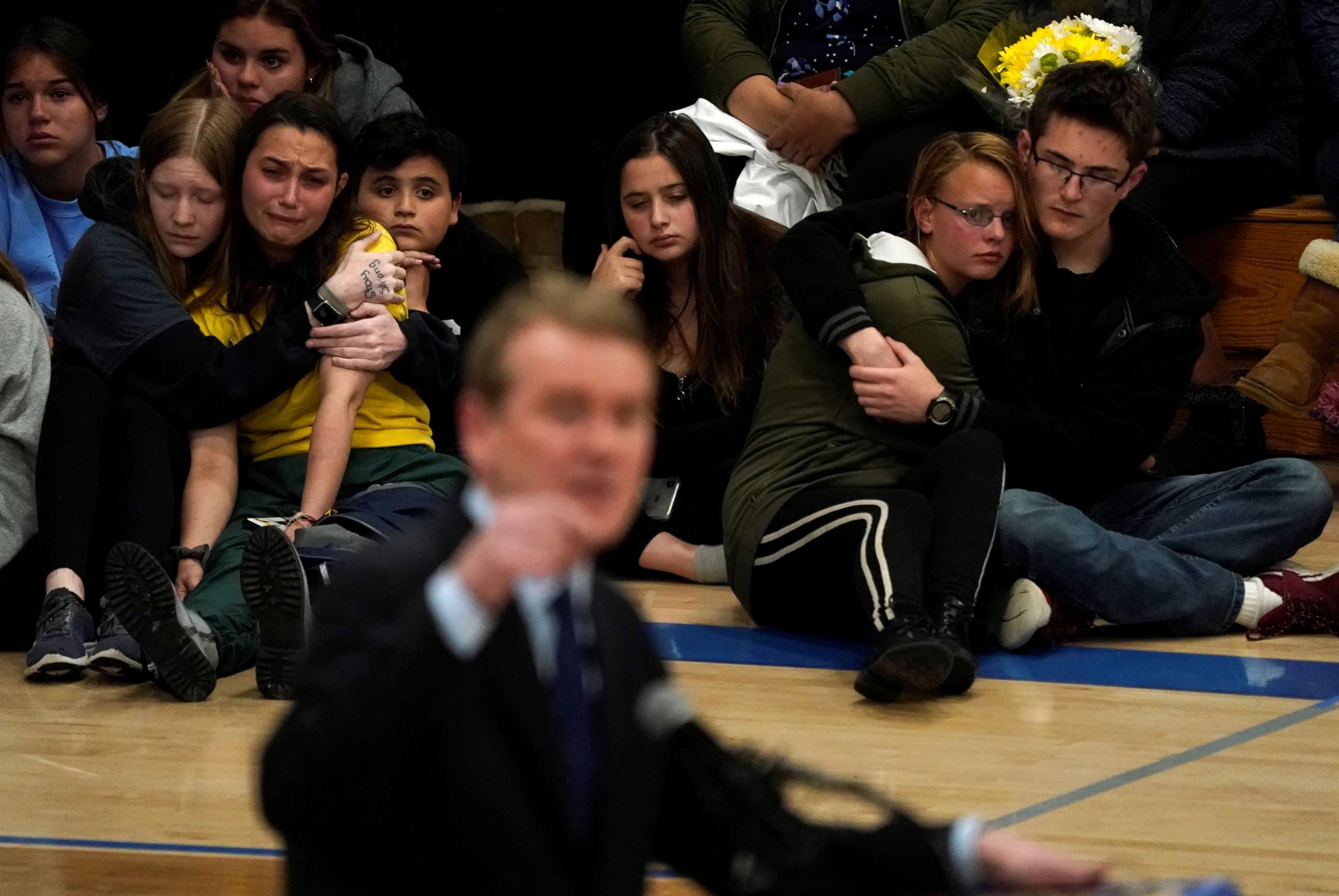 PHOTO: Students hug at a vigil for the victims of the shooting at the STEM School in Highlands Ranch, Colo., May 8, 2019, as Sen. Michael Bennett speaks.