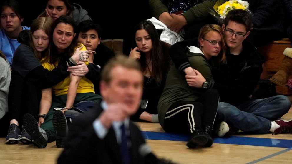 PHOTO: Students hug at a vigil for the victims of the shooting at the STEM School in Highlands Ranch, Colo., May 8, 2019, as Sen. Michael Bennett speaks.