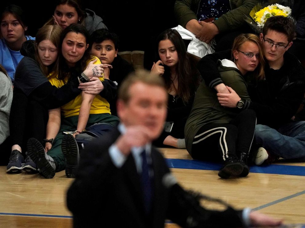 PHOTO: Students hug at a vigil for the victims of the shooting at the STEM School in Highlands Ranch, Colo., May 8, 2019, as Sen. Michael Bennett speaks.