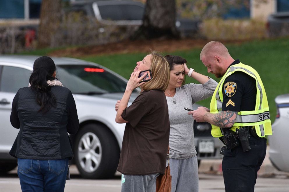PHOTO: In this May 7, 2019, file photo, parents speak with a police officer at the scene of a shooting in which at least seven students were injured at the STEM School Highlands Ranch in Highlands Ranch, Colorado.