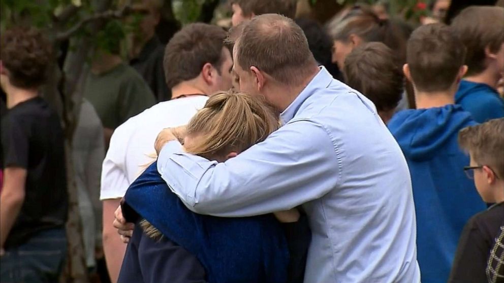 PHOTO: People hug at a meetup area after reports of a shooting at STEM School Highlands Ranch in Highlands Ranch, Colo., May 7, 2019.