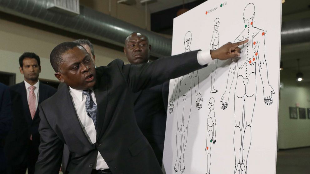 Pathologist, Dr. Bennet Omalu, gestures to a diagram showing the gun shot wounds he found on the body of police shooting victim Stephon Clark, during a news conference, March 30, 2018, in Sacramento, Calif.