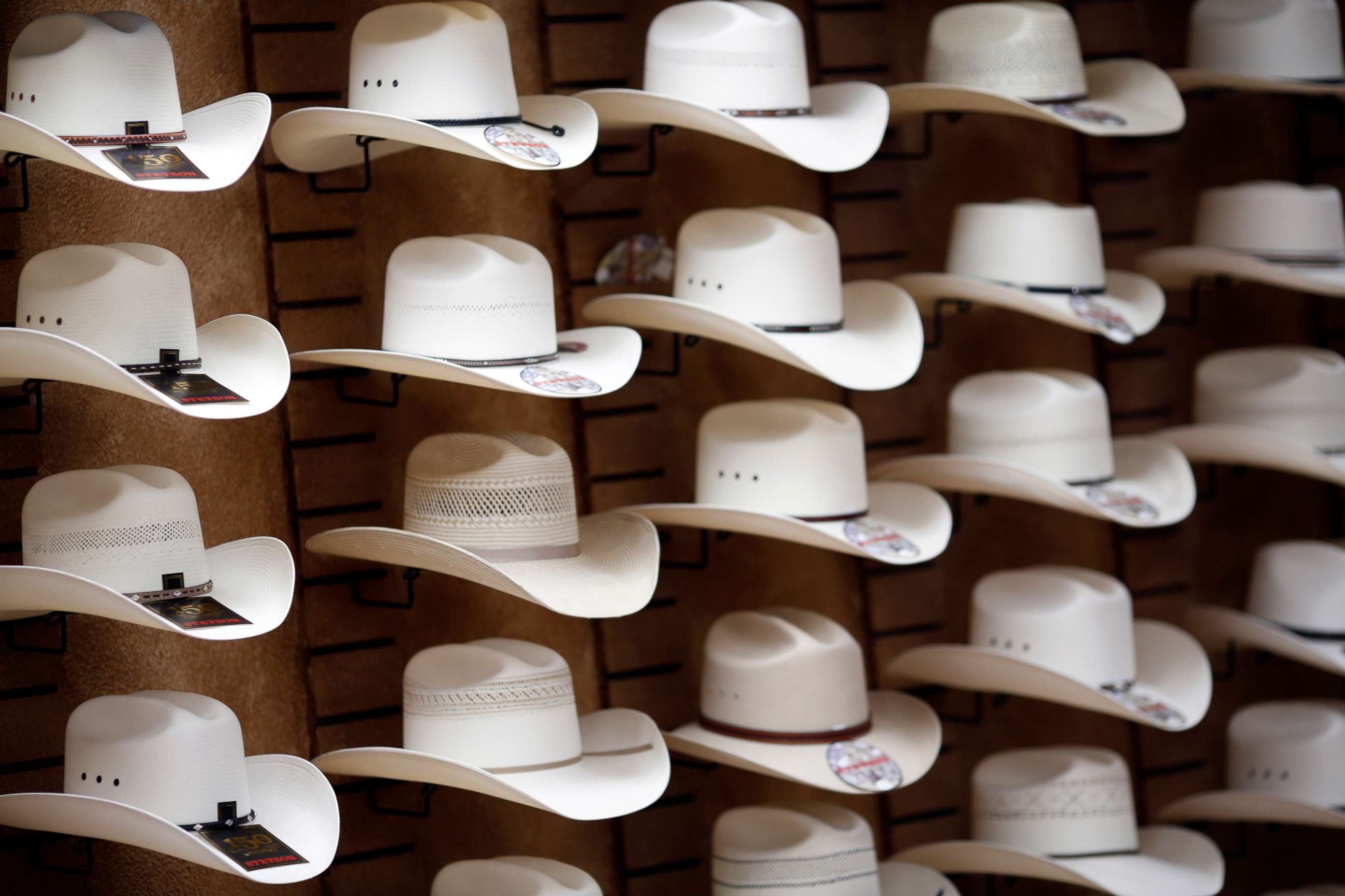 PHOTO: Stetson brand cowboy hats are displayed on a wall inside the showroom of the Hatco Inc. manufacturing facility in Garland, Texas, Aug. 28, 2015.