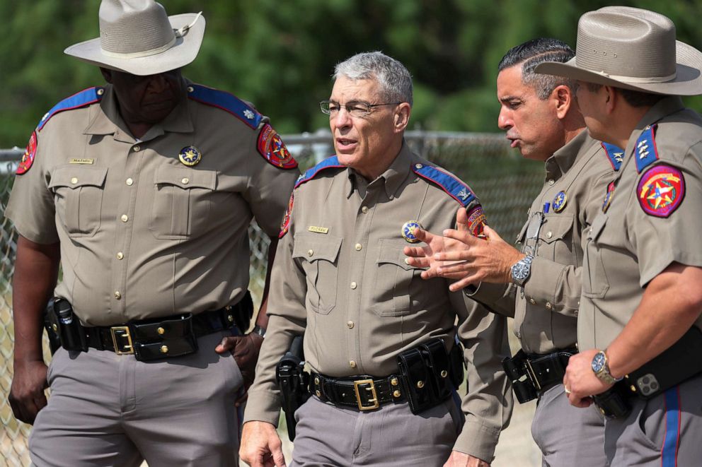 PHOTO: In this May 30, 2022, file photo, Steven C. McCraw, Director and Colonel of the Texas Department of Public Safety (2nd L), speaks with DPS State Troopers near Robb Elementary School in Uvalde, Texas.
