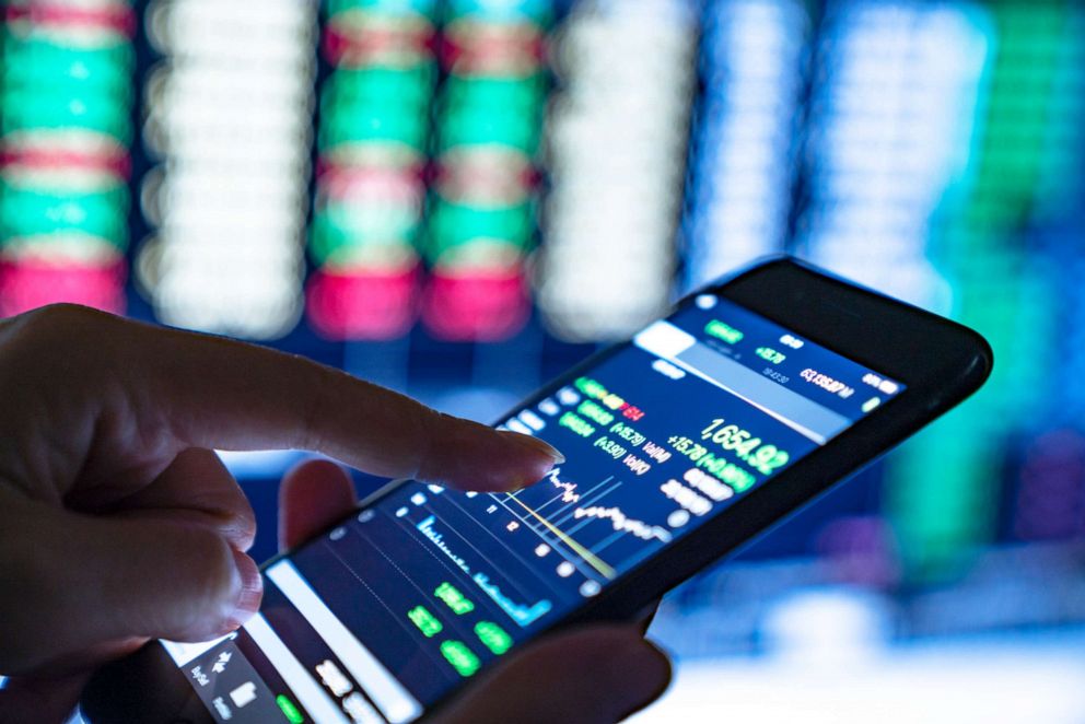 PHOTO: A businesswoman analyzes stock market charts and key performance indicators.