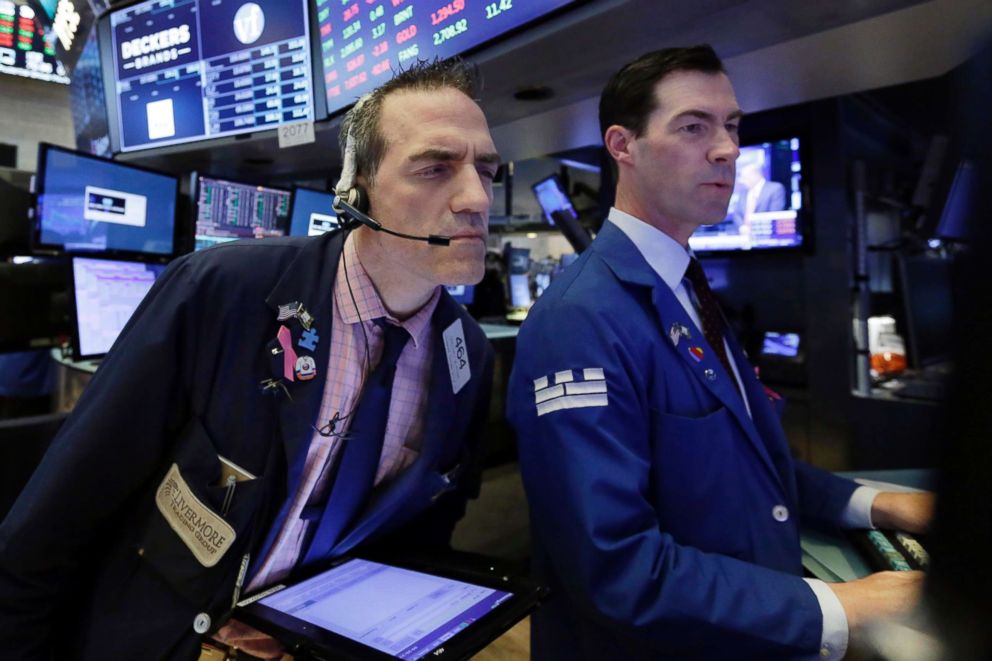 PHOTO: Trader Gregory Rowe, left, and specialist John McNierney work on the floor of the New York Stock Exchange, May 29, 2018.