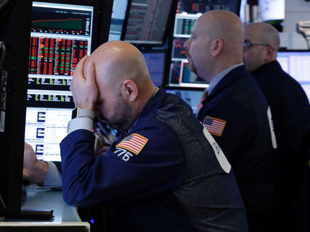 PHOTO: Traders work in a booth on the floor of the New York Stock Exchange, March 22, 2018.