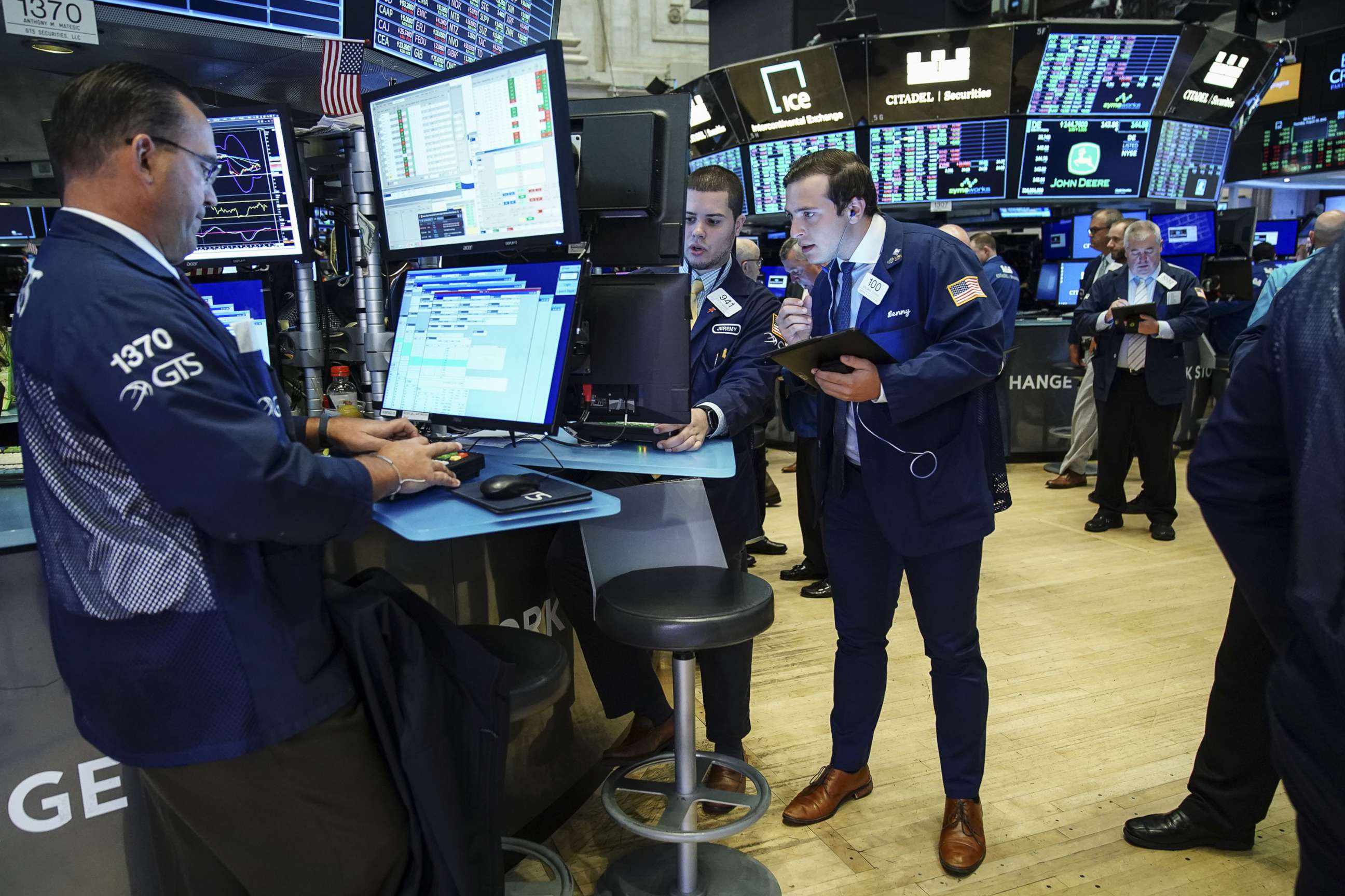 PHOTO: Traders and financial professionals work on the floor of the New York Stock Exchange at the opening bell on August 15, 2019, in New York.
