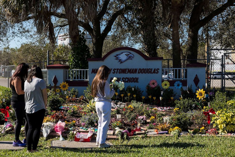PHOTO: People visit a memorial at Marjory Stoneman Douglas High School to honor those killed on the 5th anniversary of the mass shooting , Feb. 14, 2023, in Parkland, Fla.