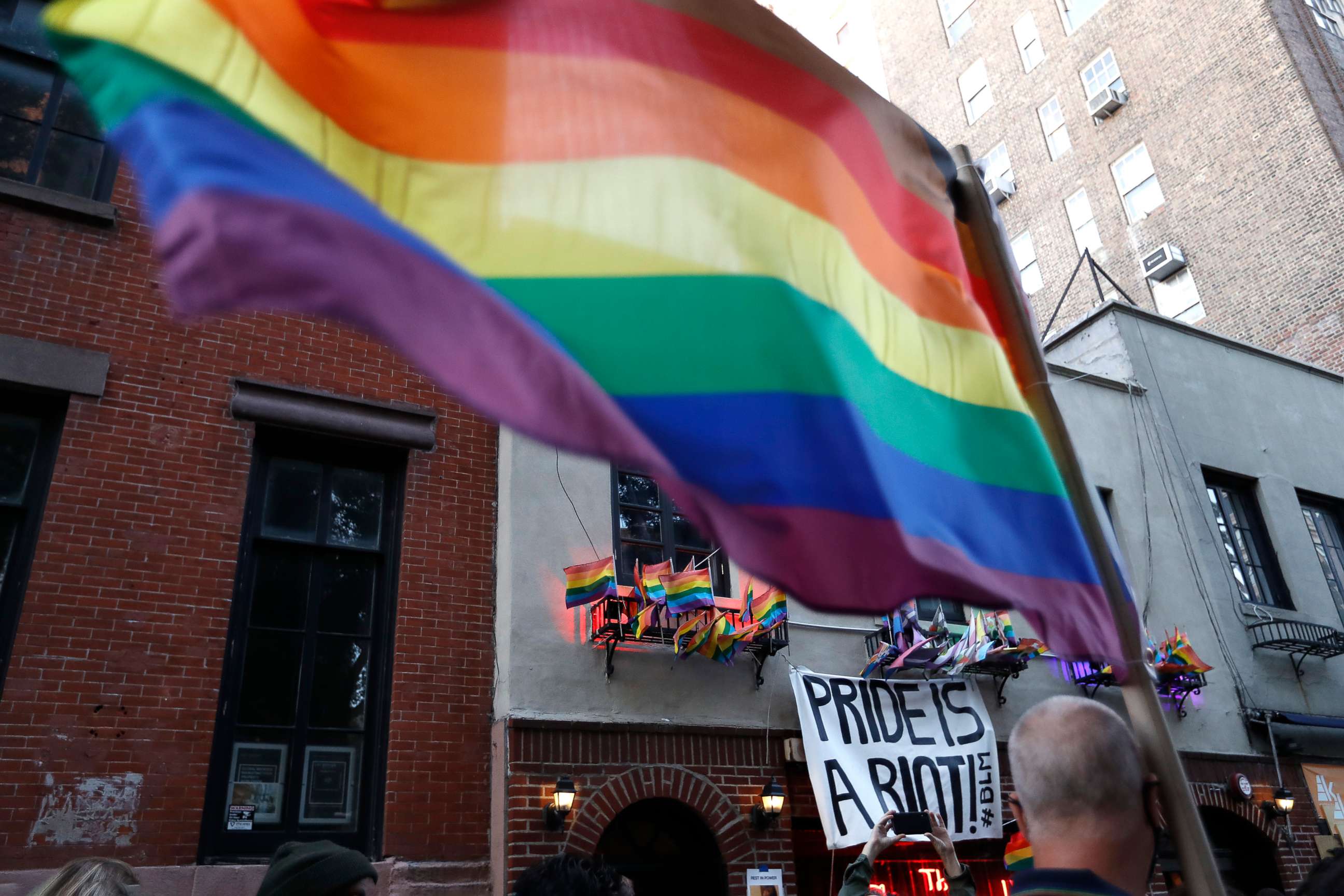 PHOTO: People gather at the historic Stonewall Inn to celebrate the LGBTQ victory, in Greenwich Village, June 15, 2020.