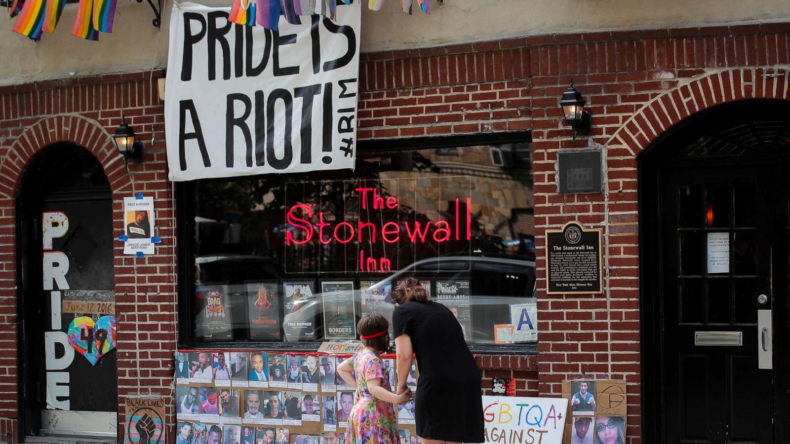 PHOTO: People wearing protective masks stand outside the closed Stonewall Inn, after the U.S. Supreme Court delivered a watershed victory for LGBT rights, in New York City, June 15, 2020.