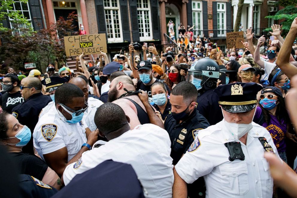 PHOTO: A demonstrator scuffles with a police officer during a joint LGBTQ and Black Lives Matter march on the 51st anniversary of the Stonewall riots in New York City, June 28, 2020.