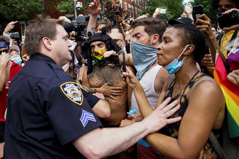 PHOTO: A demonstrator scuffles with a police officer during a joint LGBTQ and Black Lives Matter march on the 51st anniversary of the Stonewall riots in New York City, June 28, 2020.