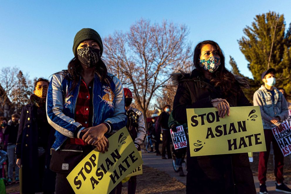 PHOTO: People hold signs during the "Asian Solidarity March" rally against anti-Asian hate in response to recent anti-Asian crime, March 18, 2021, in Minneapolis, Minnesota.