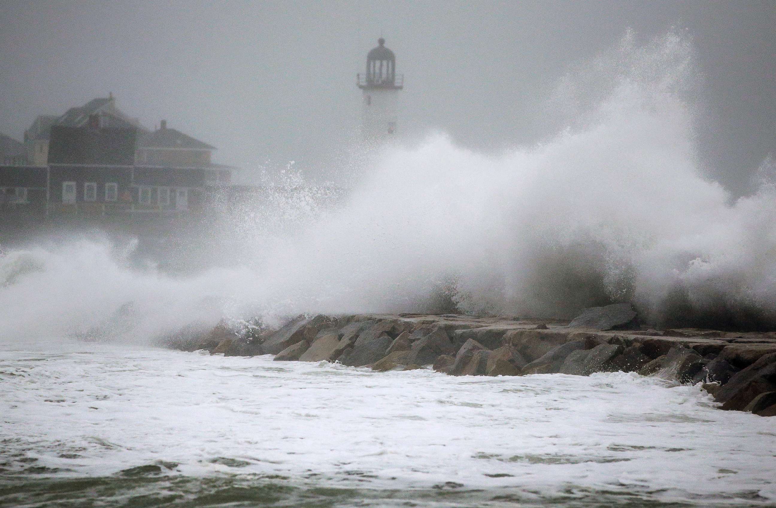 PHOTO: Waves crash against a seawall near the Scituate Lighthouse, March 2, 2018, in Scituate, Mass.