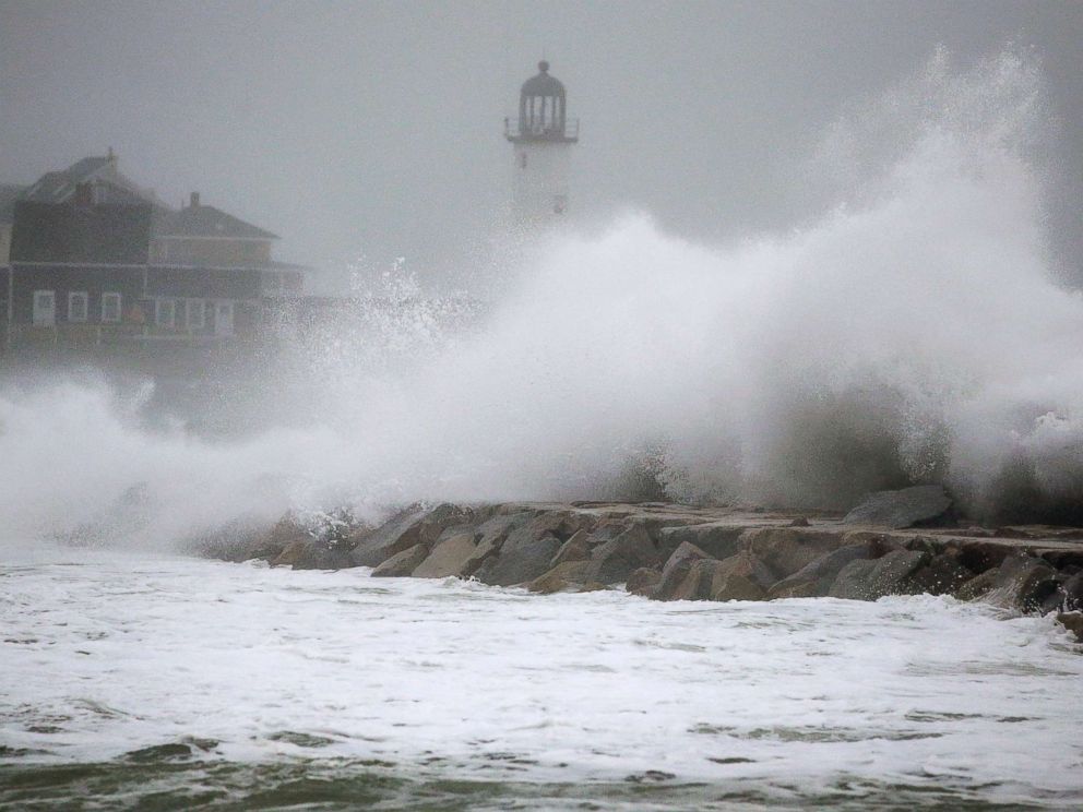 PHOTO: Waves crash against a seawall near the Scituate Lighthouse, March 2, 2018, in Scituate, Mass.