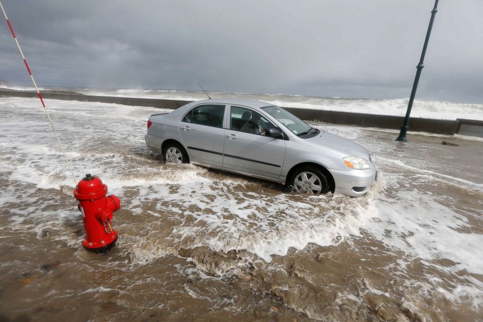 PHOTO: A car drives through flood waters in Winthrop, Mass., March 3, 2018, a day after a nor'easter pounded the Atlantic coast with hurricane-force winds and sideways rain and snow. 