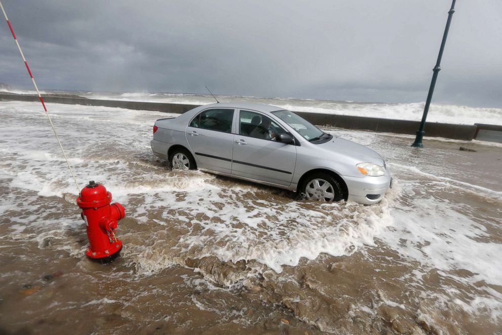 PHOTO: A car drives through flood waters in Wintrhrop, Mass., March 3, 2018, a day after a nor'easter pounded the Atlantic coast with hurricane-force winds and sideways rain and snow. 