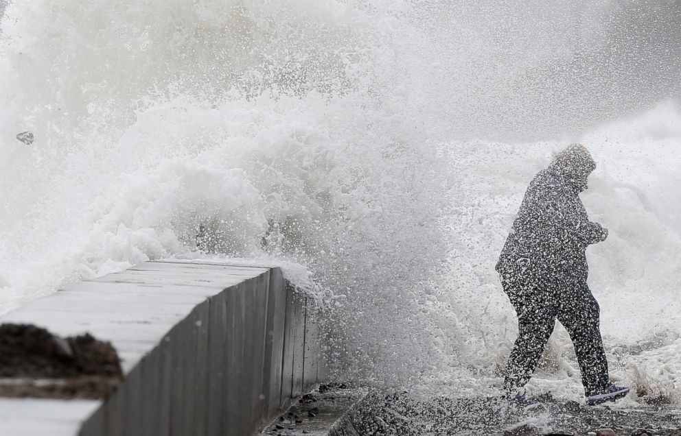 PHOTO: A woman gets caught by a wave as heavy seas continue to come ashore in Winthrop, Mass., March 3, 2018.