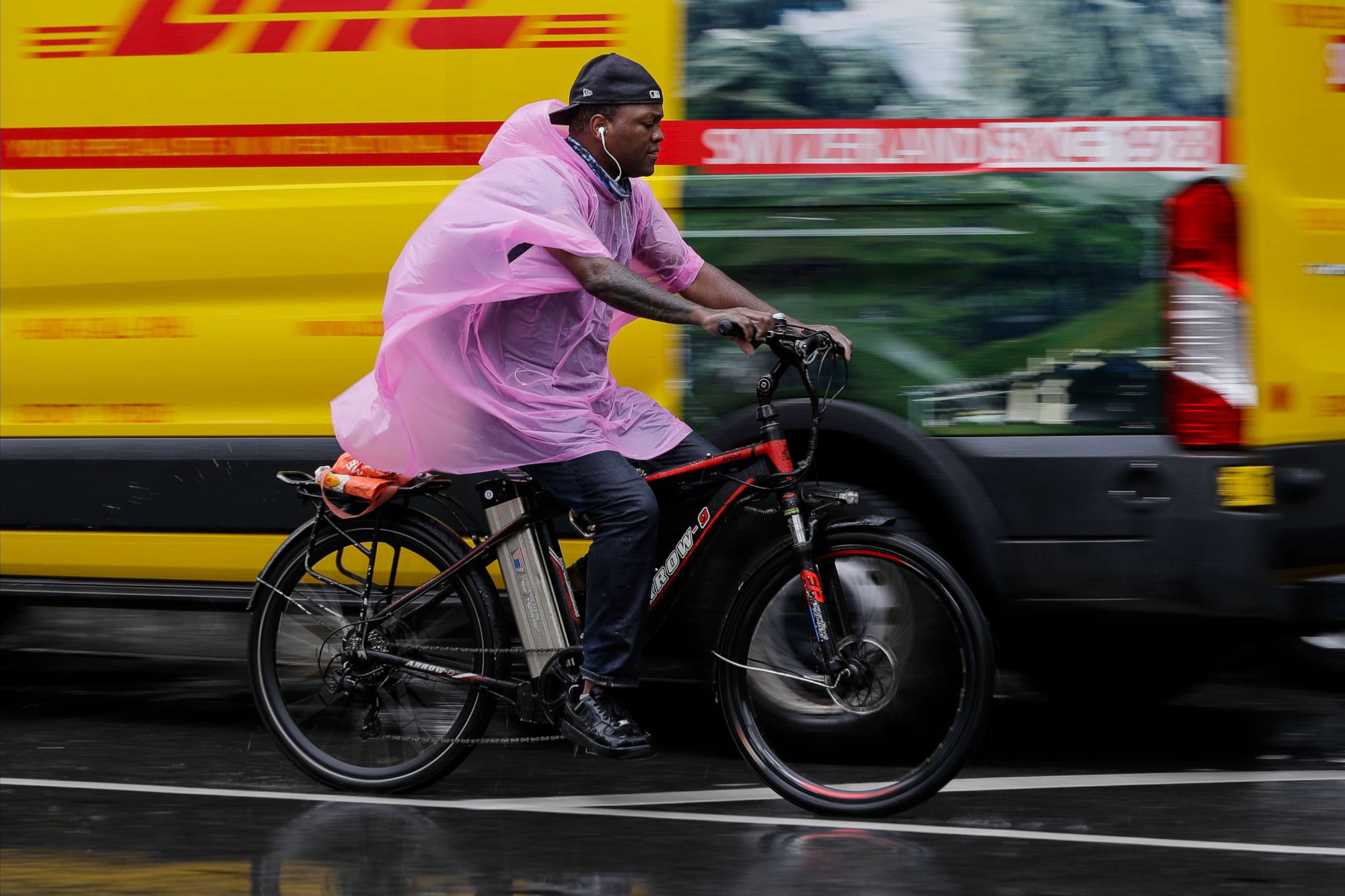 PHOTO: A cyclist uses a plastic rain as protection from rain brought by Tropical Storm Fay, July 10, 2020, in New York.