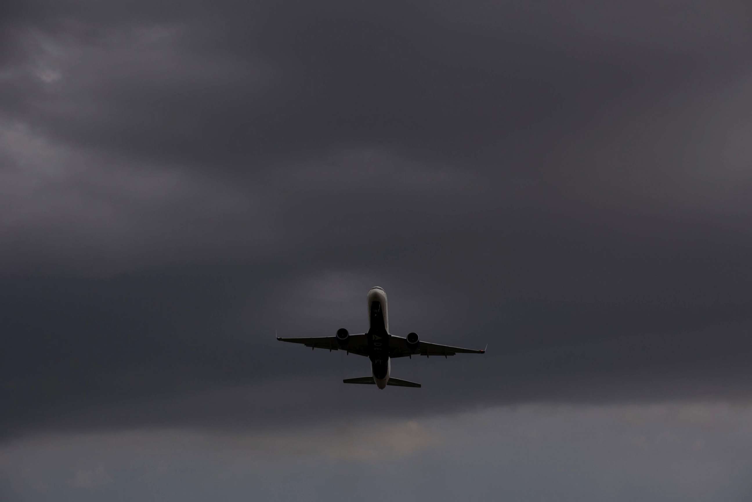PHOTO: A plane takes off from Reagan National Airport, at Gravelly Point Park as storm clouds approach in Arlington, Va., Aug. 21, 2019. 