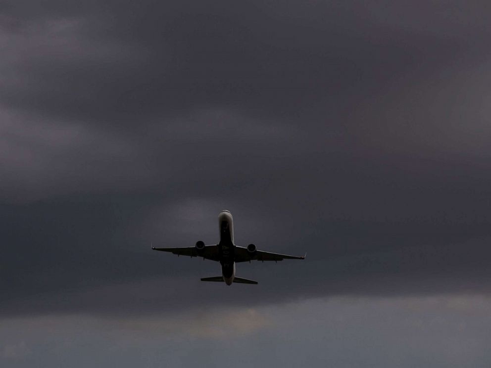 PHOTO: A plane takes off from Reagan National Airport, at Gravelly Point Park as storm clouds approach in Arlington, Va., Aug. 21, 2019.