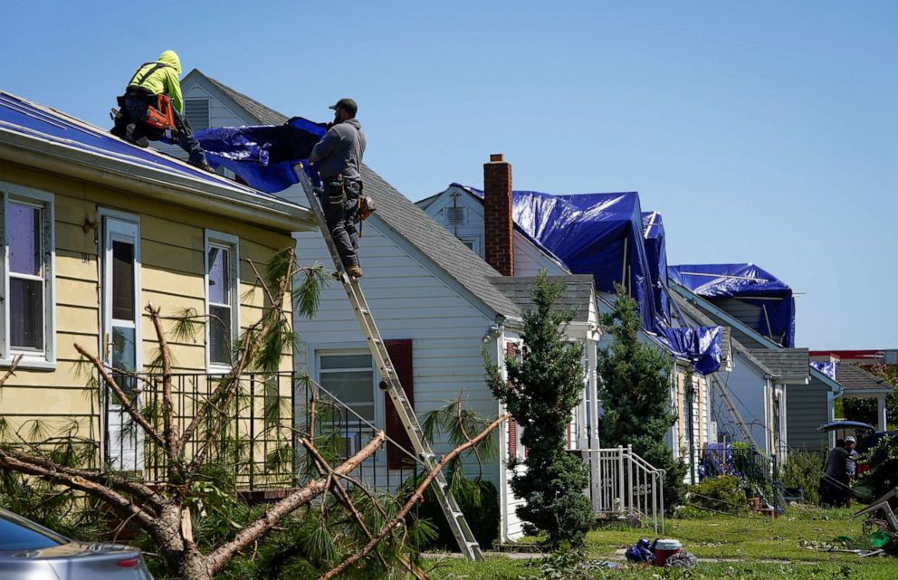 PHOTO: People work on a home's damaged roof the day after multiple homes and businesses were damaged after a tornado, caused by Tropical Rainstorm Ida, swept through Annapolis, Md., Sept. 2, 2021.