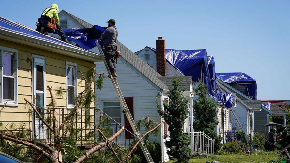 PHOTO: People work on a home's damaged roof the day after multiple homes and businesses were damaged after a tornado, caused by Tropical Rainstorm Ida, swept through Annapolis, Md., Sept. 2, 2021.