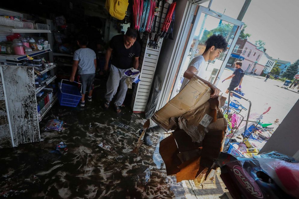 PHOTO: People remove flood-damaged merchandise from the a store that was flooded after the remnants of Tropical Storm Ida brought drenching rain, flash floods and tornadoes to parts of the northeast, in Mamaroneck, N.Y., Sept. 2, 2021.